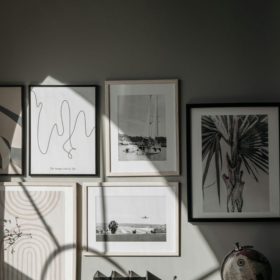 Stylishly arranged wall frames and decor create a contemporary interior space.